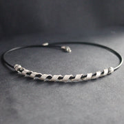 a silver helix twisted necklace on black leather band by Beverly Bartlett, UK jewellery designer
