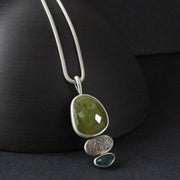 Sphene and blue tourmaline textured silver duo pendants by Carin Lindberg