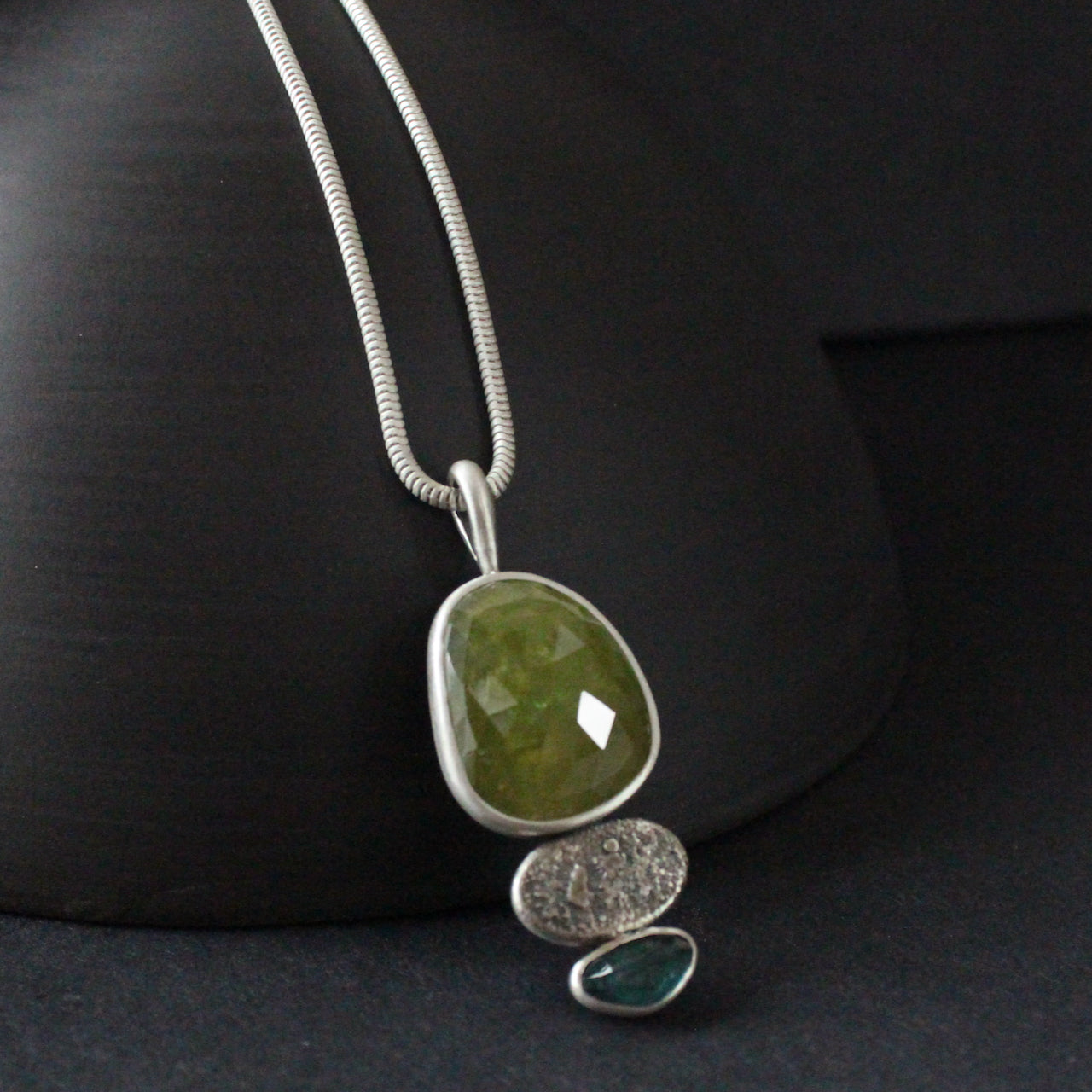 Sphene and blue tourmaline textured silver duo pendants by Carin Lindberg
