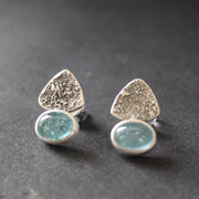 a pair of textured silver earrings with blue stone by jeweller Carin Lindberg