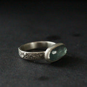 a textured silver ring with a long blue stone by jeweller Carin Lindberg.
