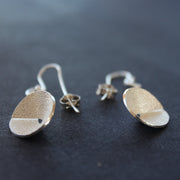 Textured silver curved and circular earrings by Beverly Bartlett.