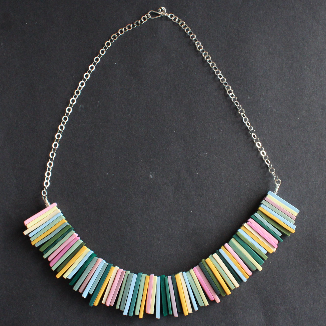 a necklace in pinks, yellow and green oblong beads by UK  jeweller Clare Lloyd