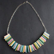 a necklace in pinks, yellow and green oblong beads by UK  jeweller Clare Lloyd