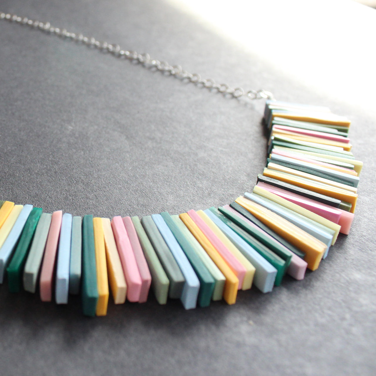 detail of a necklace in pinks, yellow and green oblong beads by jeweller Clare Lloyd