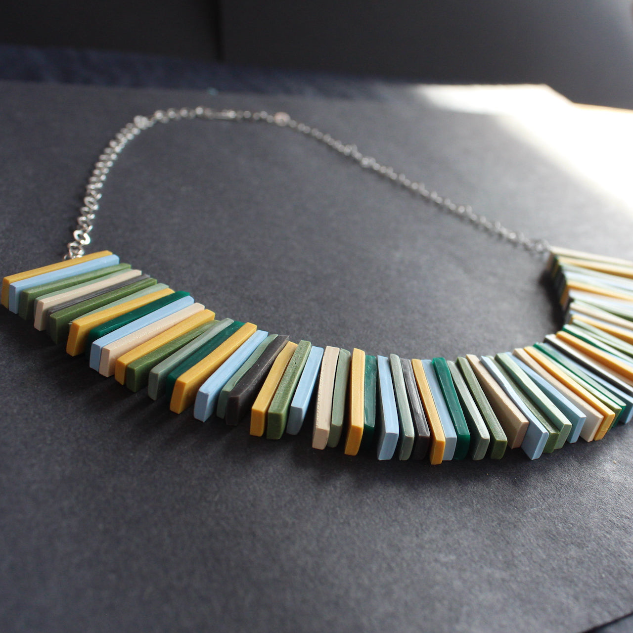 Modern deco necklace with greens, yellows and blues by Clare Lloyd