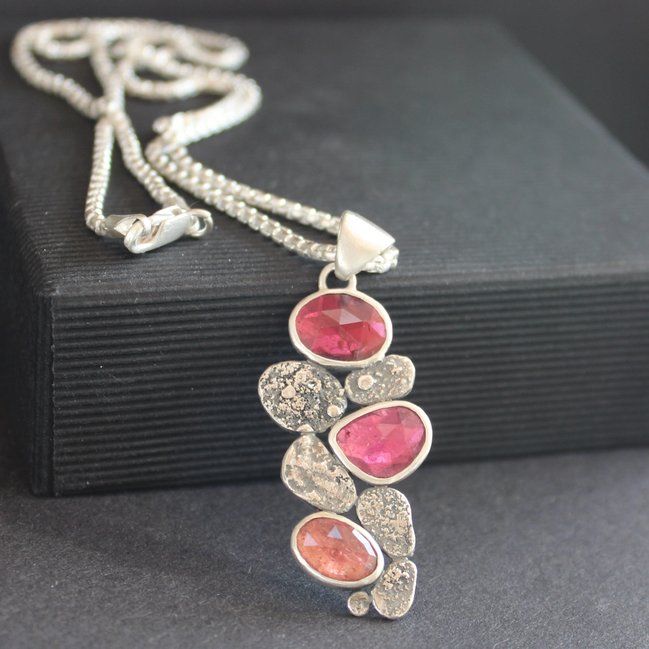 a silver pendant with silver discs and pink tourmaline stones on a sliver chain by UK Jeweller Carin Lindberg