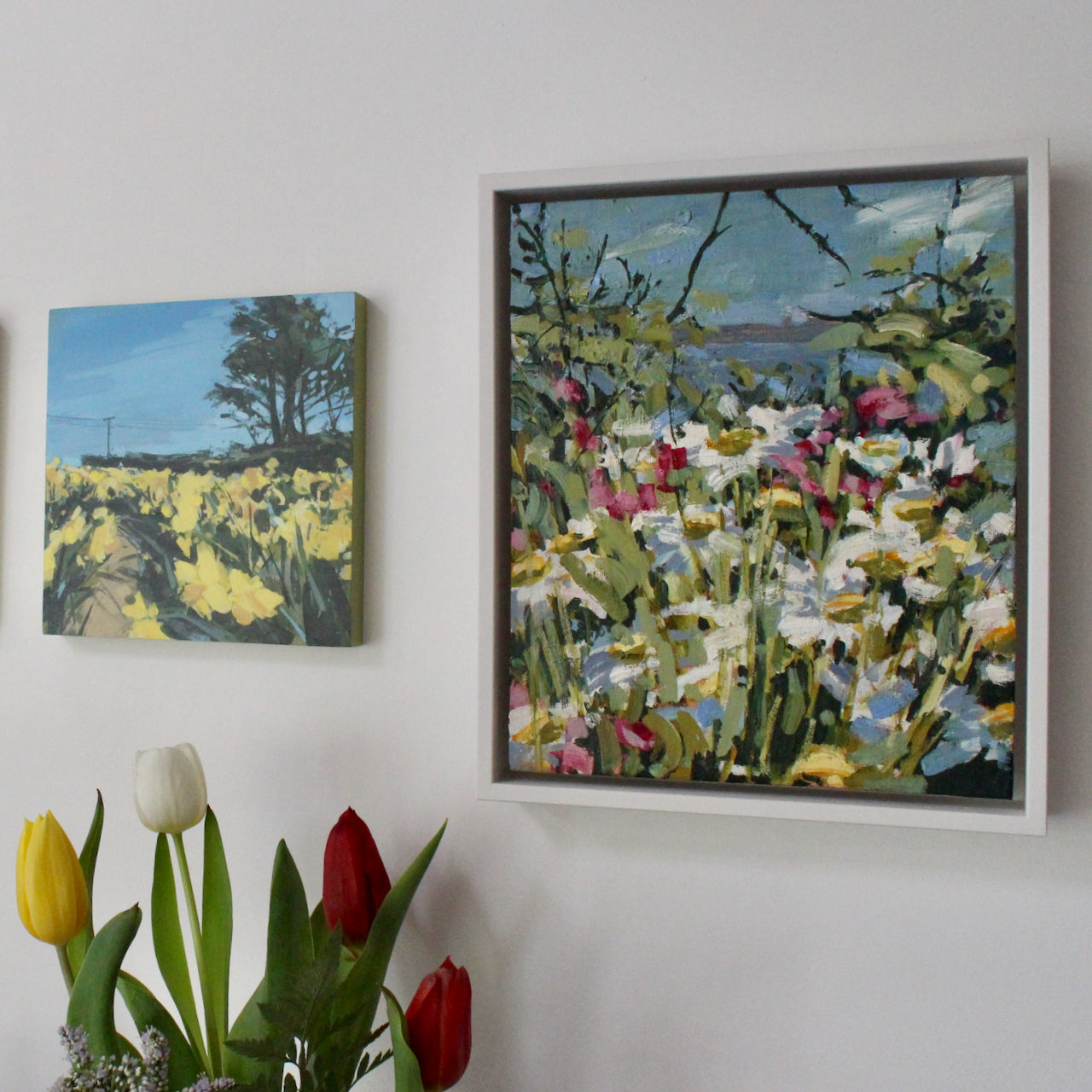 two paintings of spring flowers in fields by Cornwall artists Imogen Bone and Jill Hudson