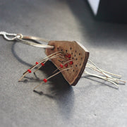 necklace of found objects wood pierced by metal strands by UK jeweller Lizzie Weir of Anatole Design