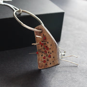 a necklace of found objects wood pierced by metal strands by UK jeweller Lizzie Weir of Anatole Design