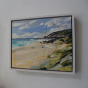 a framed painting of a Cornish beach with pale sand and dark cliffs by Jill Hudson, Cornwall artist