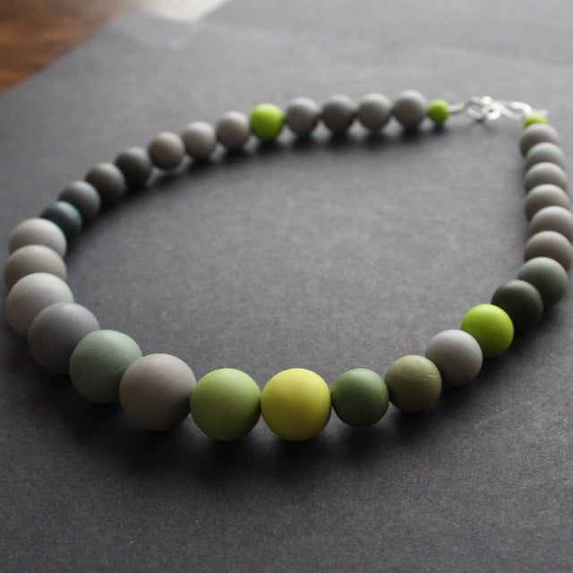 a green and grey bead necklace by Clare Lloyd