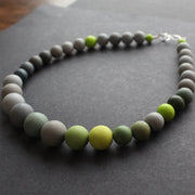 a green and grey bead necklace by Clare Lloyd