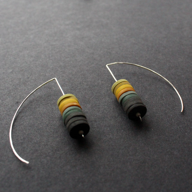 a pair of earrings made by Clare Lloyd from small multicoloured discs on silver wire