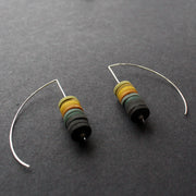 a pair of earrings made by Clare Lloyd from small multicoloured discs on silver wire