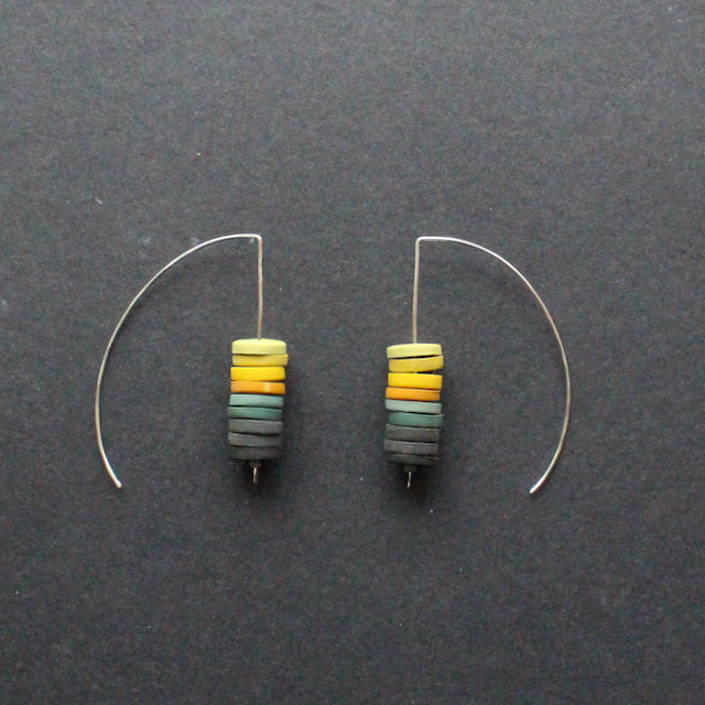 a pair of earrings made by Clare Lloyd from small multicoloured discs on silver wire