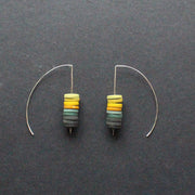a pair of earrings made by Clare Lloyd from small multicoloured discs on silver wire
