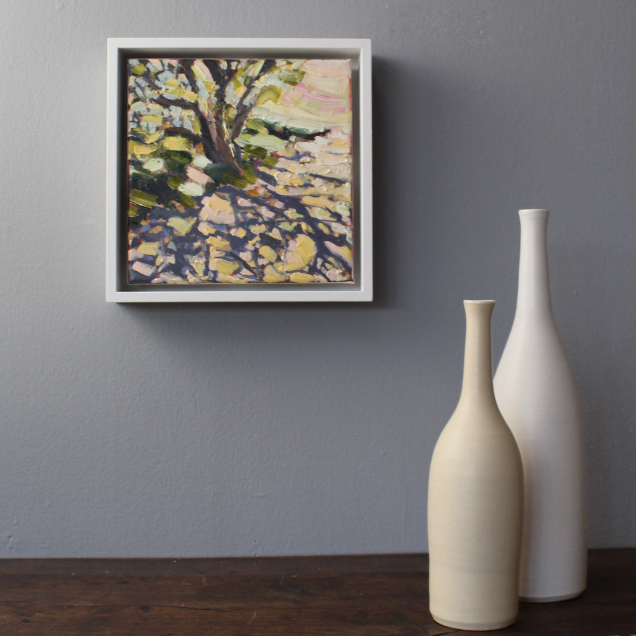 Jill Hudson abstract oil painting framed and on a grey wall next to two ceramic bottles by UK ceramicist Lucy Burley