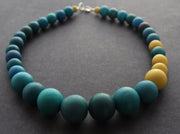 Graduated bead necklace with teal blues, greens and yellow by Clare Lloyd