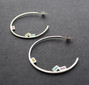 Abstract large rigid hoop earrings with small coloured squares by Clare Lloyd