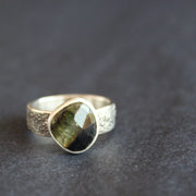a textured silver ring with a dark green stone by UK jeweller Carin Lindberg