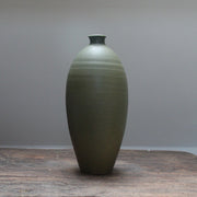 Dark green bottle on a wooden table