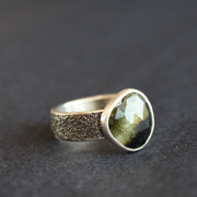 textured silver ring with a dark green stone by UK jeweller Carin Lindberg