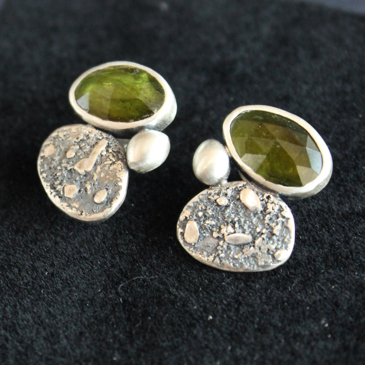 a pair of silver stud earrings with a green stone set in silver by Carin Lindberg UK jewellery designer