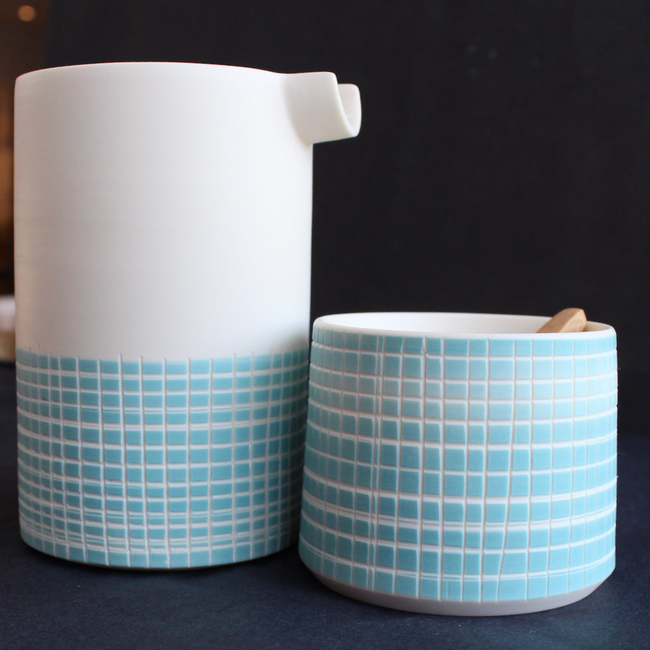 porcelain pourer and condiment bowl by Kathryn Sherriff of By the Line Pottery they are made of porcelain with a blue cross hatch design which covers the whole bowl and the bottom half of the pourer