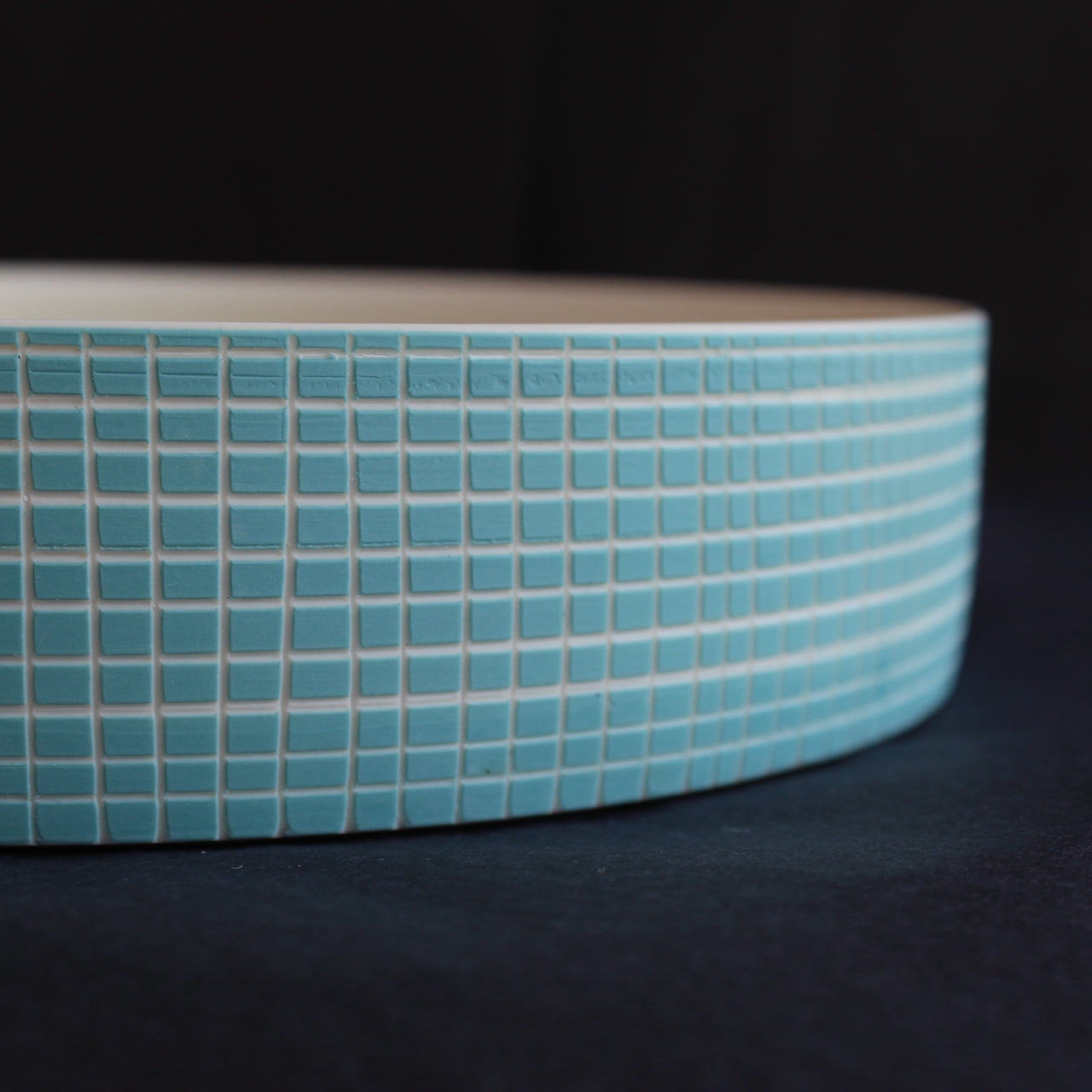 detail of a ceramic serving dish with blue cross hatch design by Kathryn Sherriff of By the Line Pottery