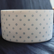 close up of a deep porcelain serving dish by Kathryn Sherriff of By the Line Pottery it is decorated on the exterior with small blue circles