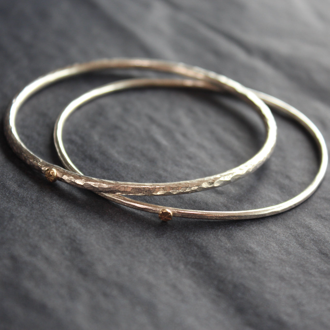 pair of narrow silver bangles by Cornwall jewellery designer Lucy Spink