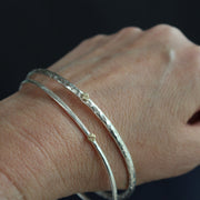 two silver bangles by Cornwall jewellery designer Lucy Spink