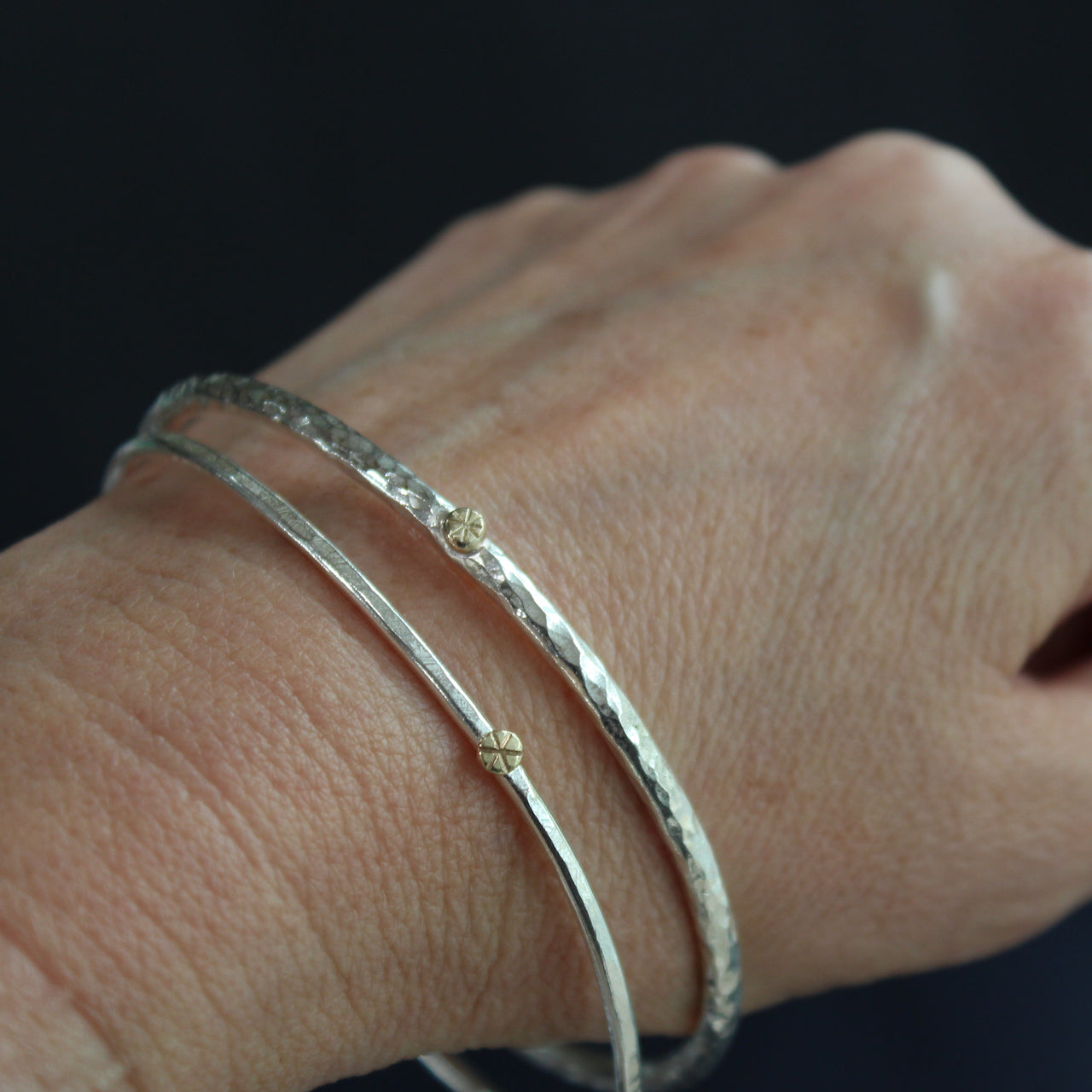 two silver bangles by Cornwall jewellery designer Lucy Spink