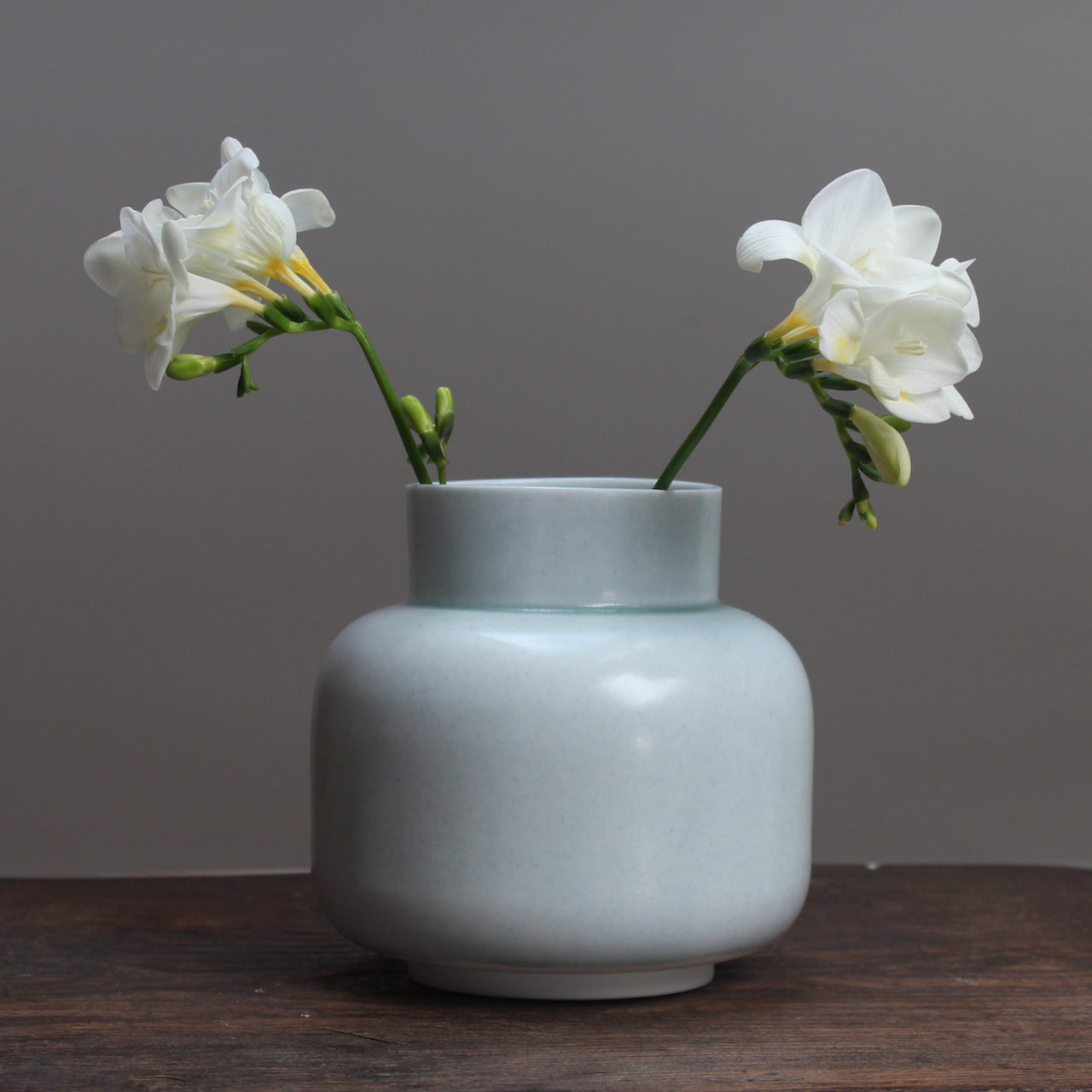 Pale Green ceramic vase by ceramicist Laura Plant with freesias