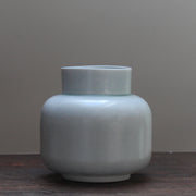 Pale Green ceramic vase by ceramicist Laura Plant on a wooden table