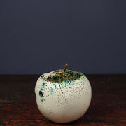 large ceramic white apple with a gold stalk and glaze effects by Remon Jephcott a Cornish based ceramic artist