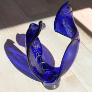 a tall blue glass sculpture with white detail by UK glass artist Benjamin Lintell