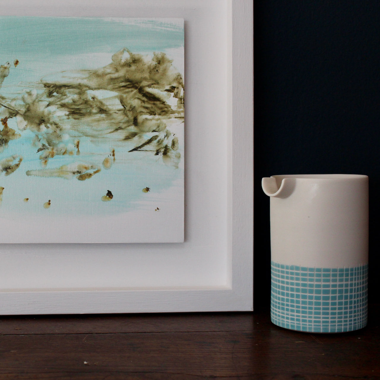 close up detail of a pale blue, white and brown abstract Katy Brown painting of flotsam on a sandy beach