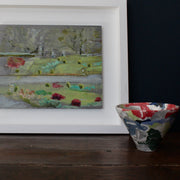 oil painting by Cornish based artist Katy Brown with trees in the distance, bushes, and red flowers