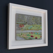 framed painting of Mount Edgcumbe Park with turquoise blue, green grass and prink flowers 
