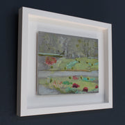 framed painting of Mount Edgcumbe Park with turquoise blue, green grass and prink flowers