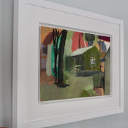 an oil painting in a white frame by Cornwall artist Heath Hearn of a green shed with a white roof in the clearing of some trees