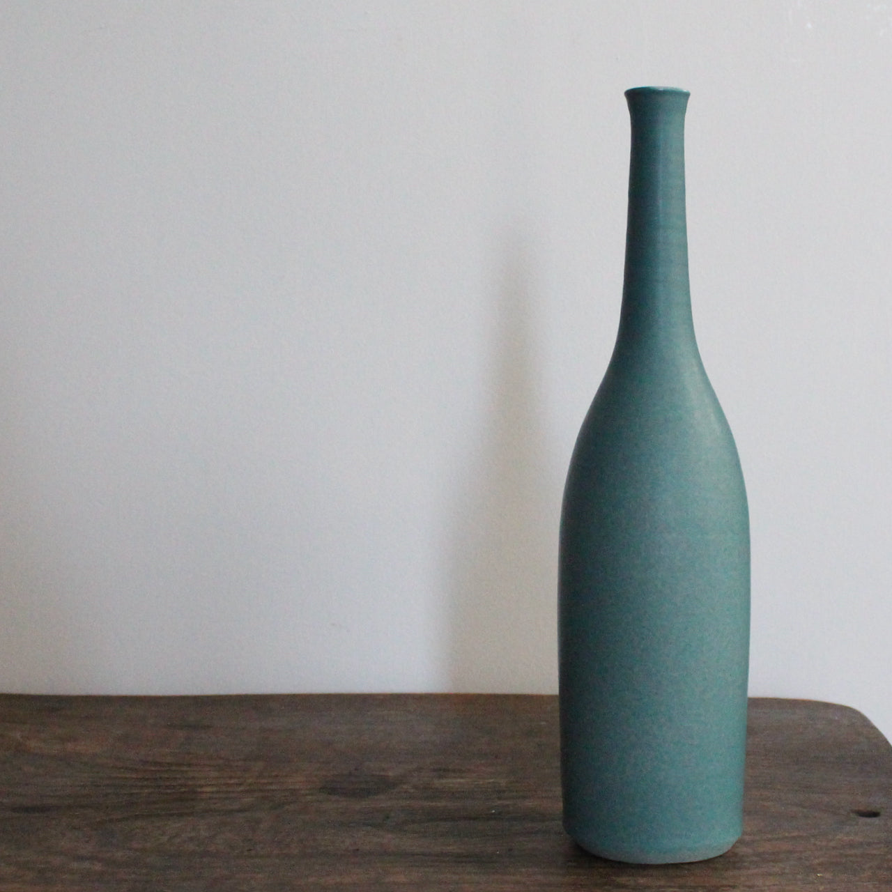 a teal coloured ceramic bottle by UK ceramicist Lucy Burley.