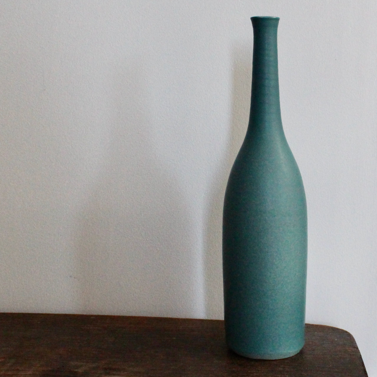 a teal coloured ceramic bottle by UK ceramic artist Lucy Burley