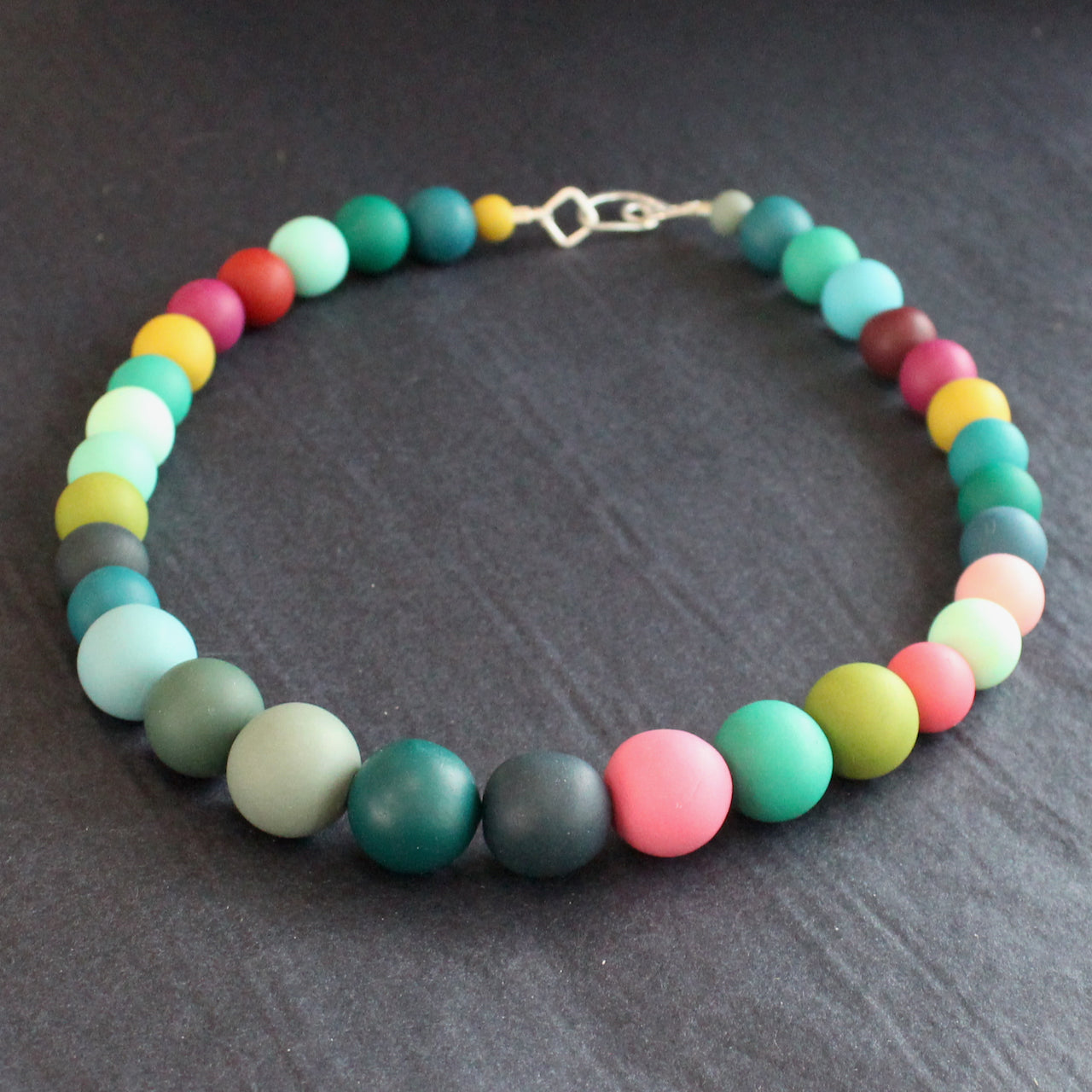 Claire Lloyd necklace of round beads in greens, pinks, blues and yellow