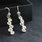 Carin Lindberg  silver drop earrings with small diamonds encased in silver