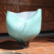 Glass buckled vessel in green and white by Benjamin Lintell