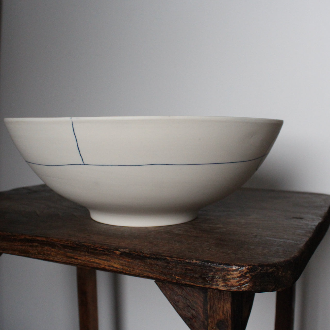 large white porcelain bowl with two blue lines on exterior by UK ceramicist Liz O'Dwyer 