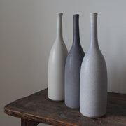 three ceramic bottles in shades of grey by Lucy Burley